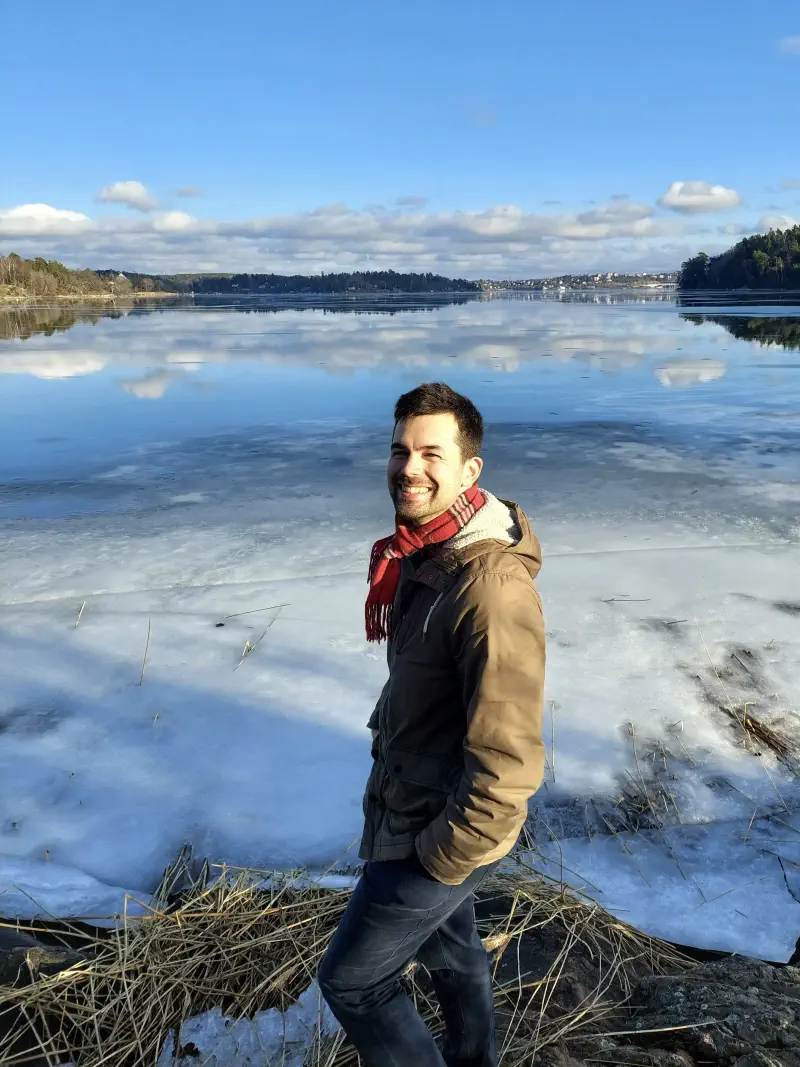 Pierre Mesure standing in front of a frozen lake