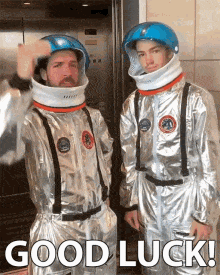 Two amateur astronauts wishing good luck before taking the elevator